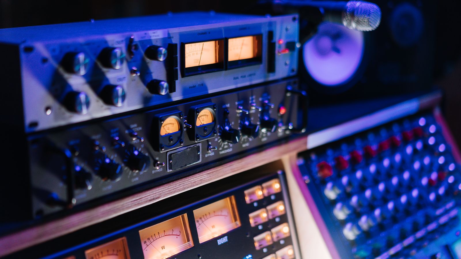 Professional audio processing equipment and mixing controls in a studio
