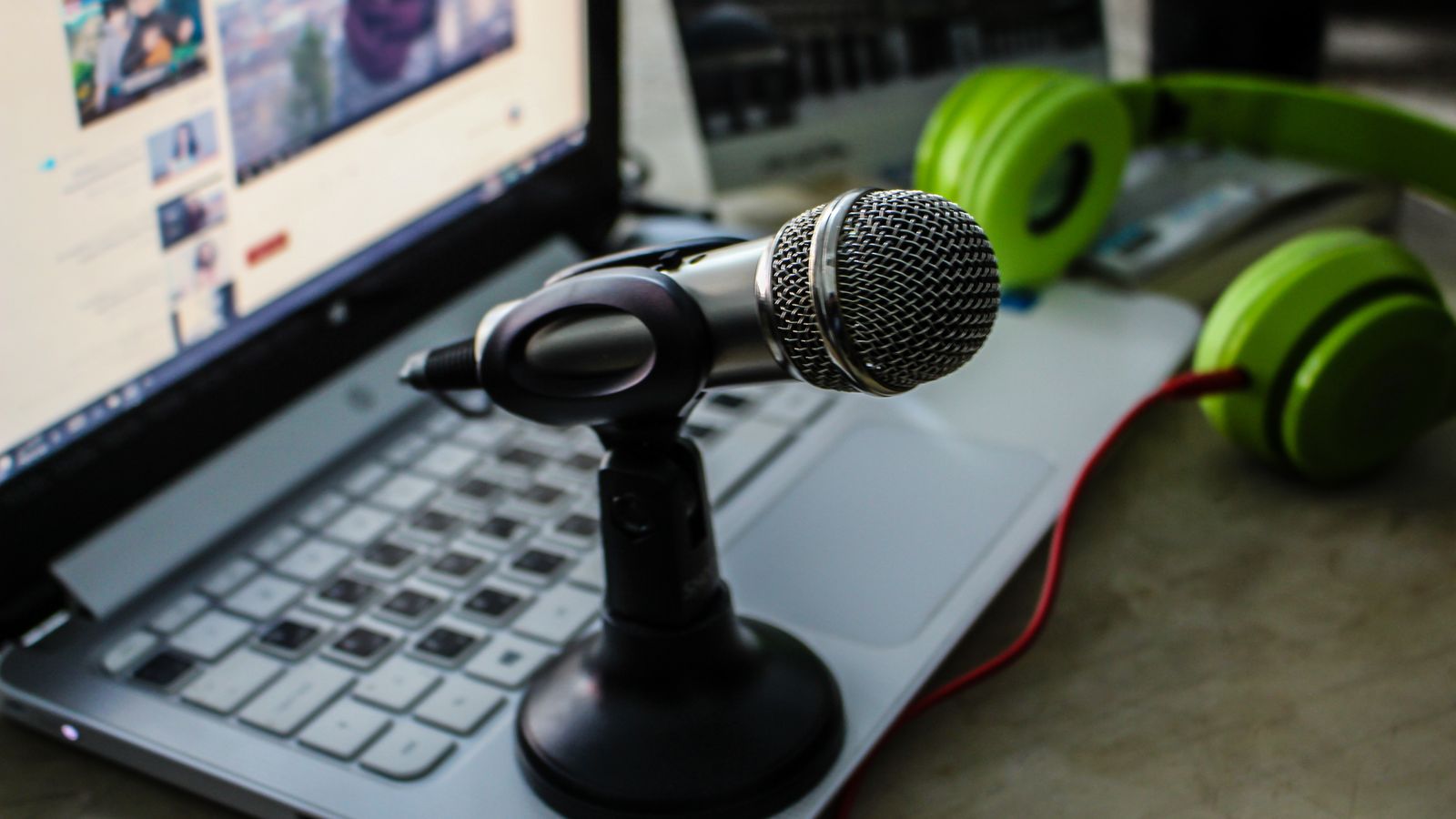 Microphone, laptop, and headphones prepared for speech recording