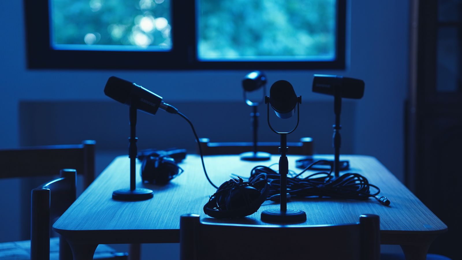 Remote podcast studio with multiple microphones arranged around a table